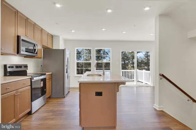 a kitchen with a stove and a wooden floor