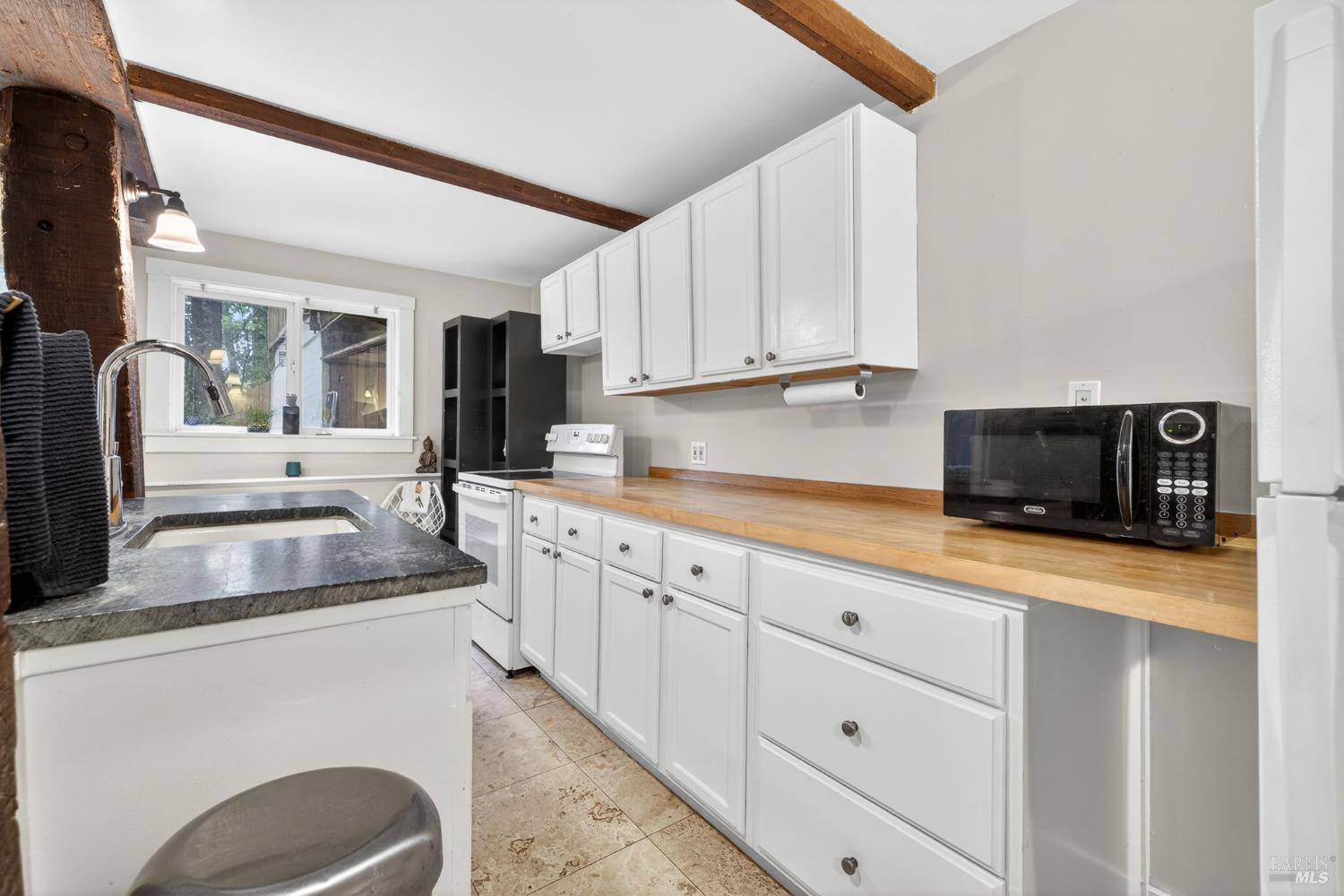 17731 Old Monte Rio Road Guerneville, CA 95446 - Photo 29 of 57 a kitchen with granite countertop a sink a stove and cabinets