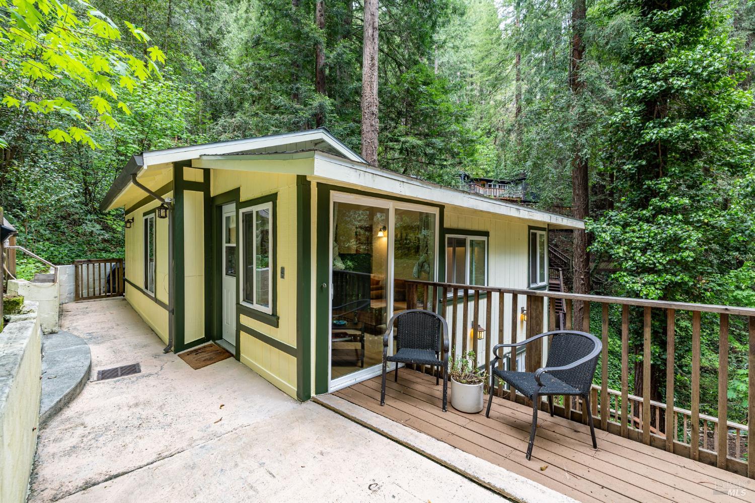 17731 Old Monte Rio Road Guerneville, CA 95446 - Photo 4 of 57 a view of a chair and table on the wooden deck