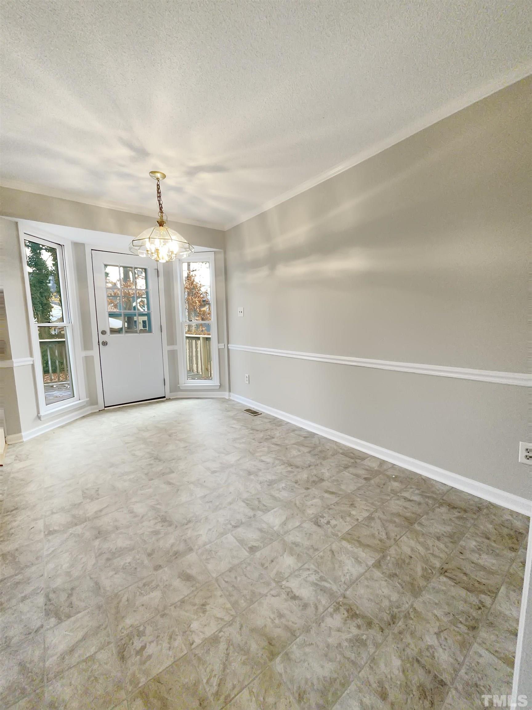 7316 Ewing Place Raleigh, NC 27616 - Photo 2 of 19 a view of an empty room with chandelier