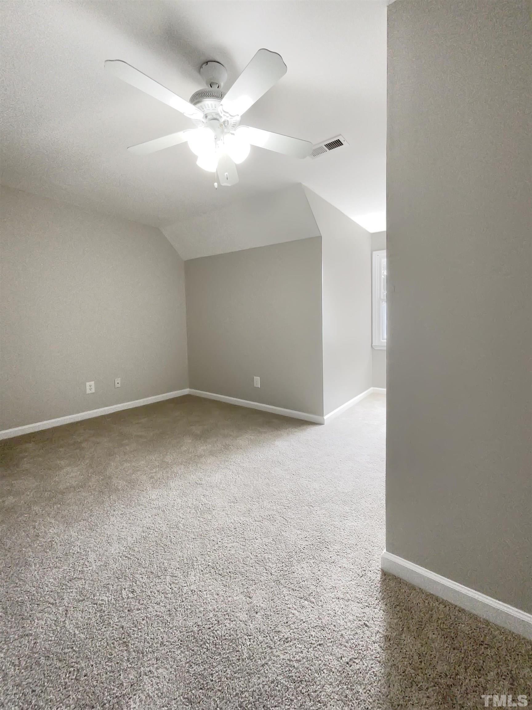 7316 Ewing Place Raleigh, NC 27616 - Photo 12 of 19 an empty room with a ceiling fan and window