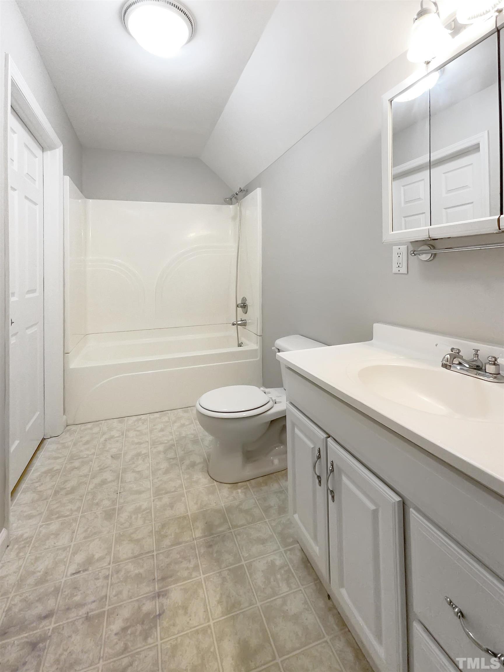 7316 Ewing Place Raleigh, NC 27616 - Photo 14 of 19 a bathroom with a sink a toilet and bathtub