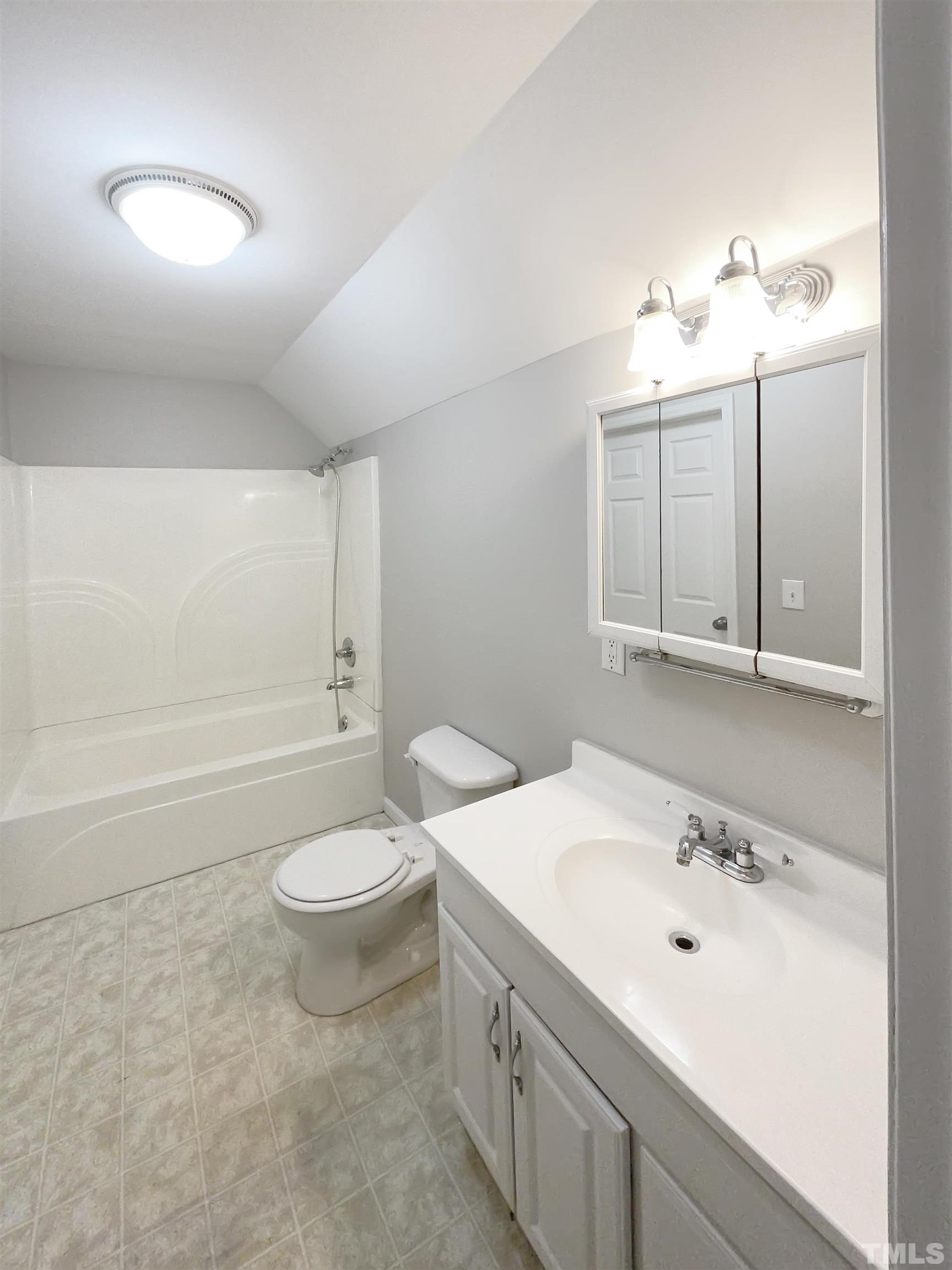 7316 Ewing Place Raleigh, NC 27616 - Photo 15 of 19 a bathroom with a double vanity sink toilet and a mirror