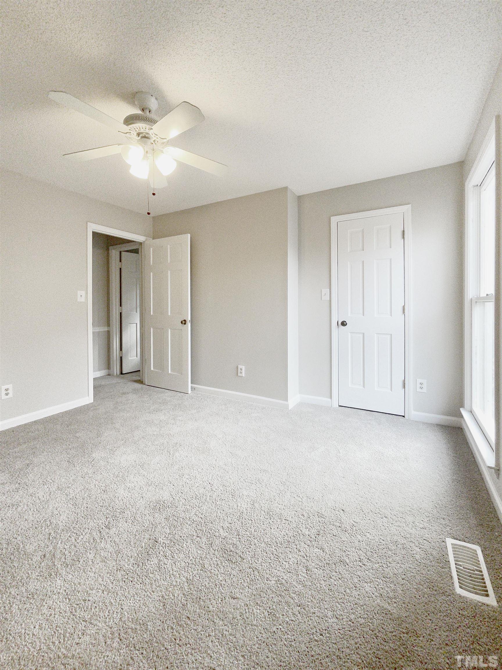 7316 Ewing Place Raleigh, NC 27616 - Photo 7 of 19 a view of an empty room with a ceiling fan