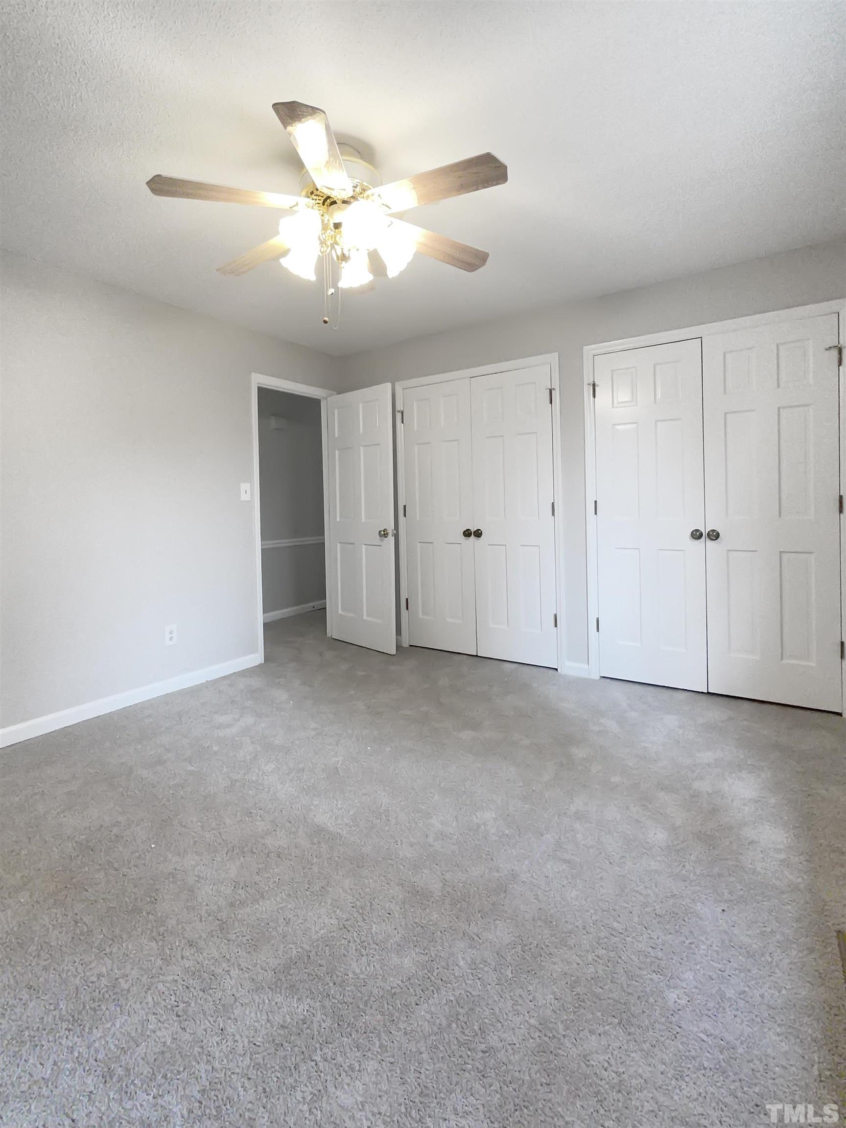 7316 Ewing Place Raleigh, NC 27616 - Photo 8 of 19 a view of an empty room with a chandelier fan