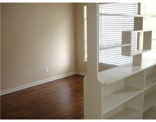 a view of wooden floor and windows in a room