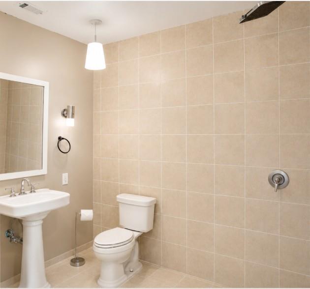 1500 Bonham Street Commerce, TX 75428 - Photo 24 of 29 a bathroom with a sink a toilet and shower