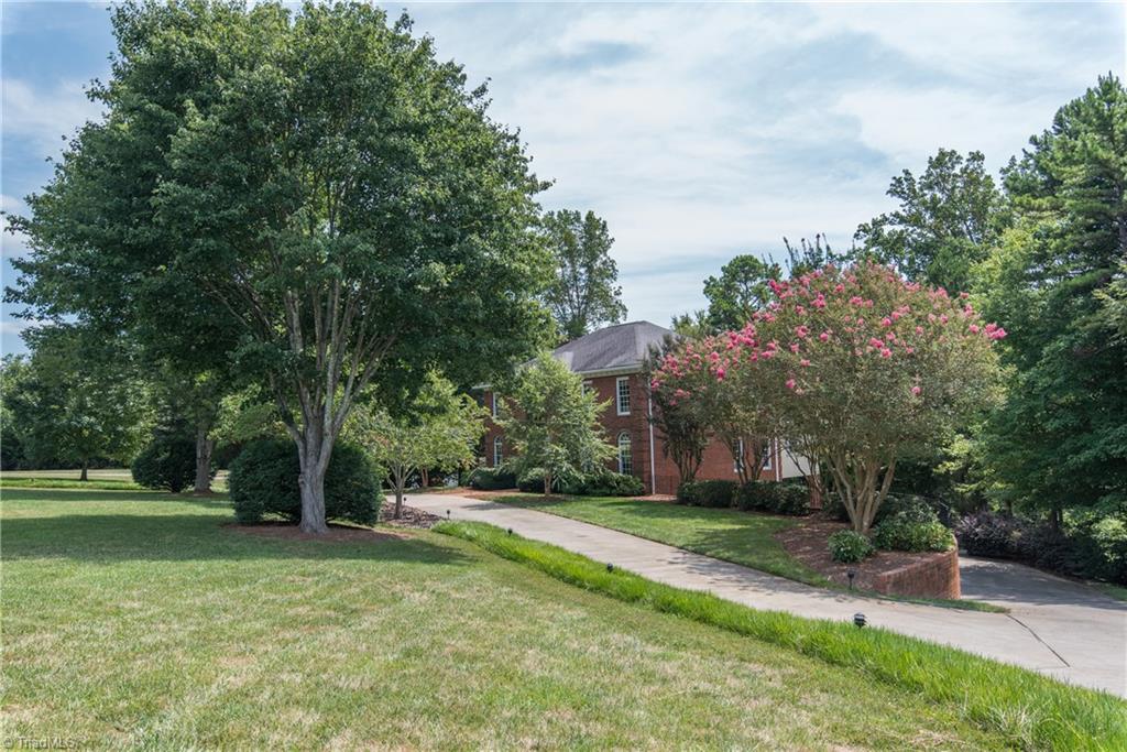 1511 Carters Grove Road Clemmons, NC 27012 - Photo 2 of 30 Long Circular driveway and entrance to lower level basement garage and carport.