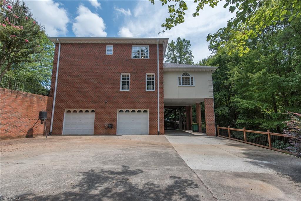 1511 Carters Grove Road Clemmons, NC 27012 - Photo 5 of 30 Basement garage entrance and carport area. The carport area makes a great space for entertaining with the deck stairs entrance.