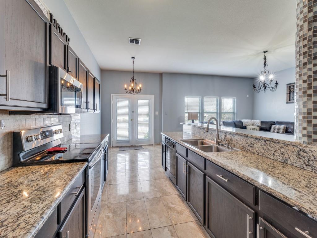 305 Sheridan Road Oak Point, TX 75068 - Photo 11 of 25 a kitchen with stainless steel appliances granite countertop a sink stove and refrigerator