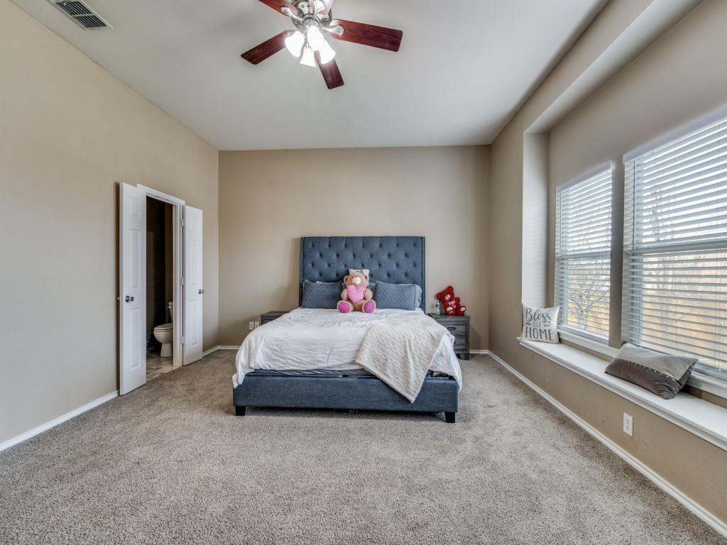 305 Sheridan Road Oak Point, TX 75068 - Photo 14 of 25 a spacious bedroom with a bed and a large window