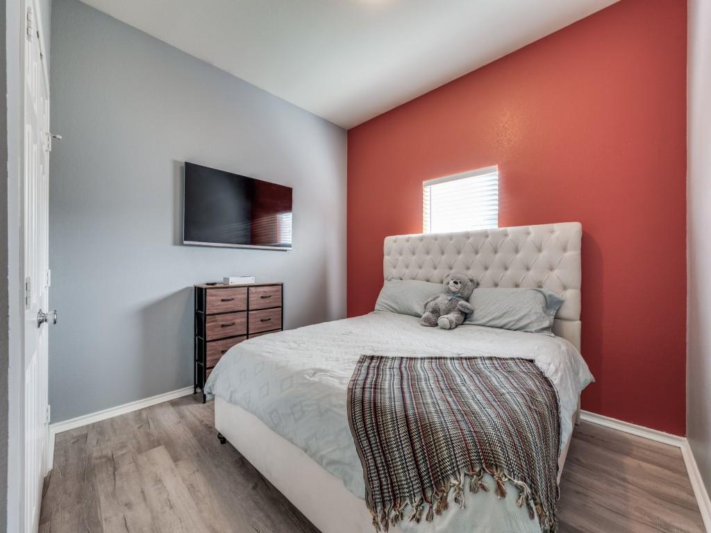 305 Sheridan Road Oak Point, TX 75068 - Photo 18 of 25 a bedroom with a bed and a flat screen tv