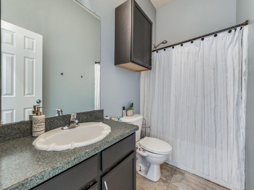 305 Sheridan Road Oak Point, TX 75068 - Photo 19 of 25 a bathroom with a granite countertop sink toilet and a mirror