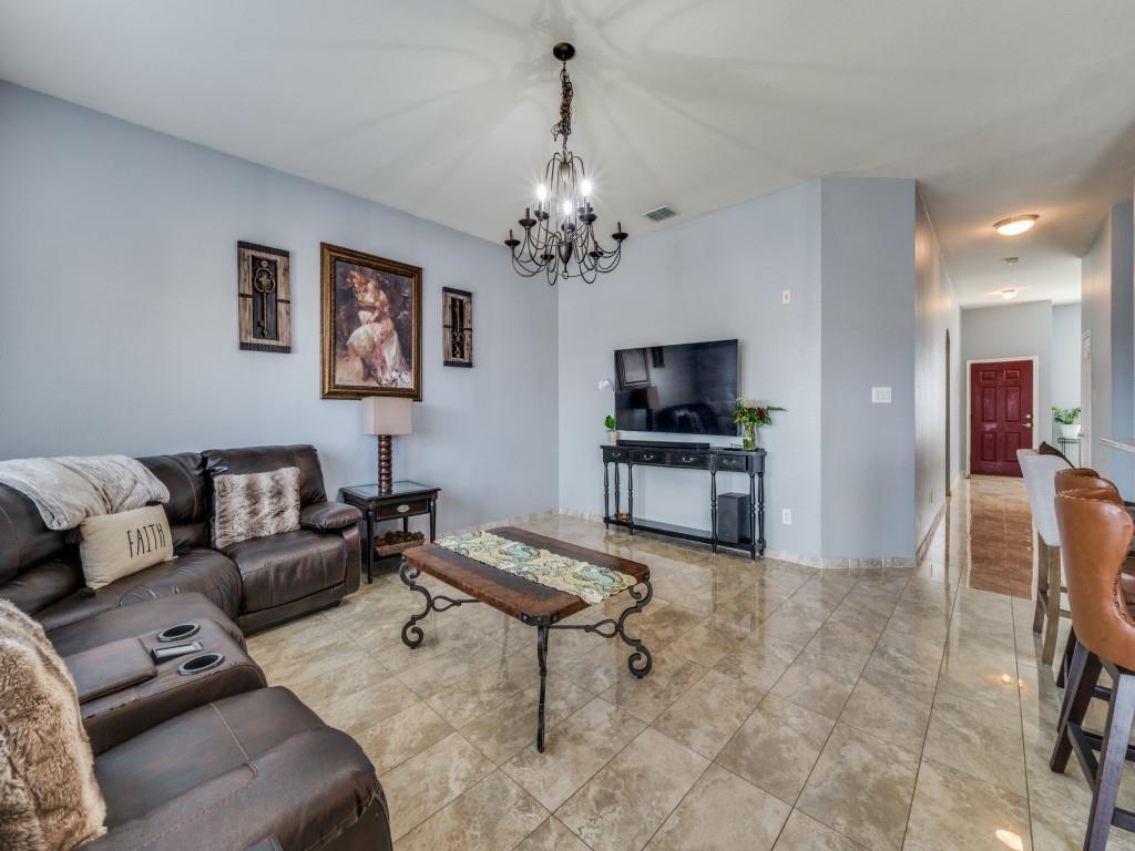 305 Sheridan Road Oak Point, TX 75068 - Photo 8 of 25 a living room with furniture and a chandelier