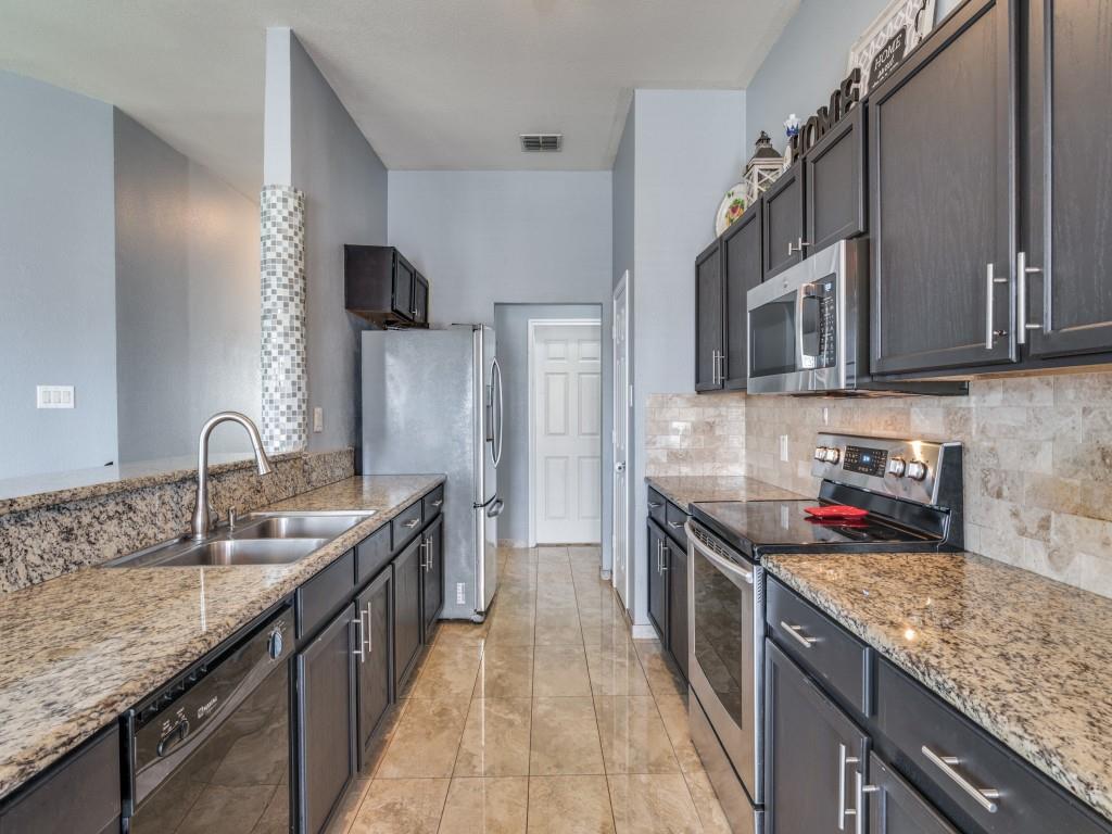 305 Sheridan Road Oak Point, TX 75068 - Photo 10 of 25 a kitchen with stainless steel appliances granite countertop a sink stove and refrigerator
