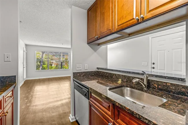 a view of a sink a microwave and cabinets in the kitchen