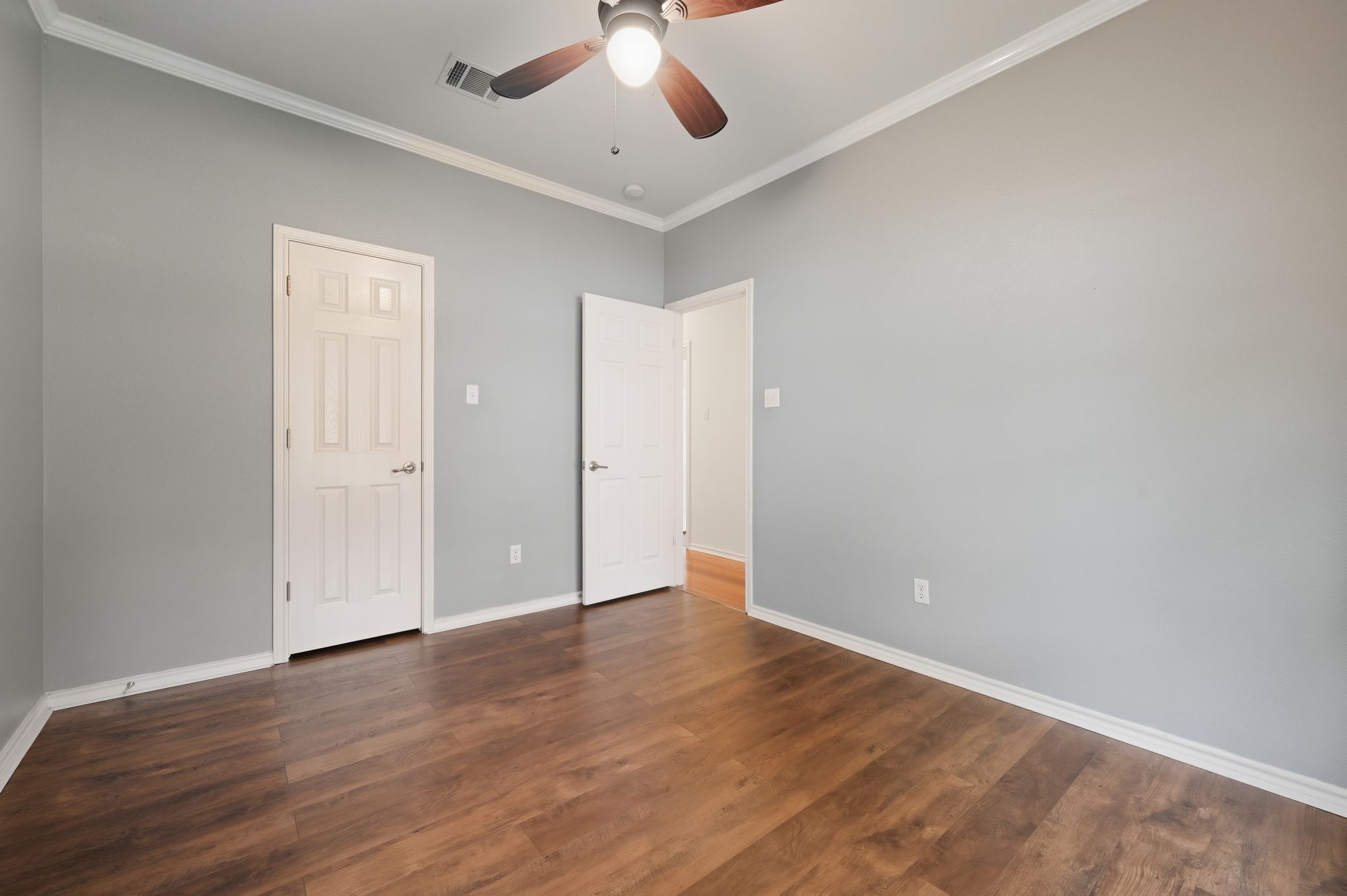 202 Muscovy Lane Cedar Park, TX 78613 - Photo 23 of 34 an empty room with wooden floor ceiling fan and windows