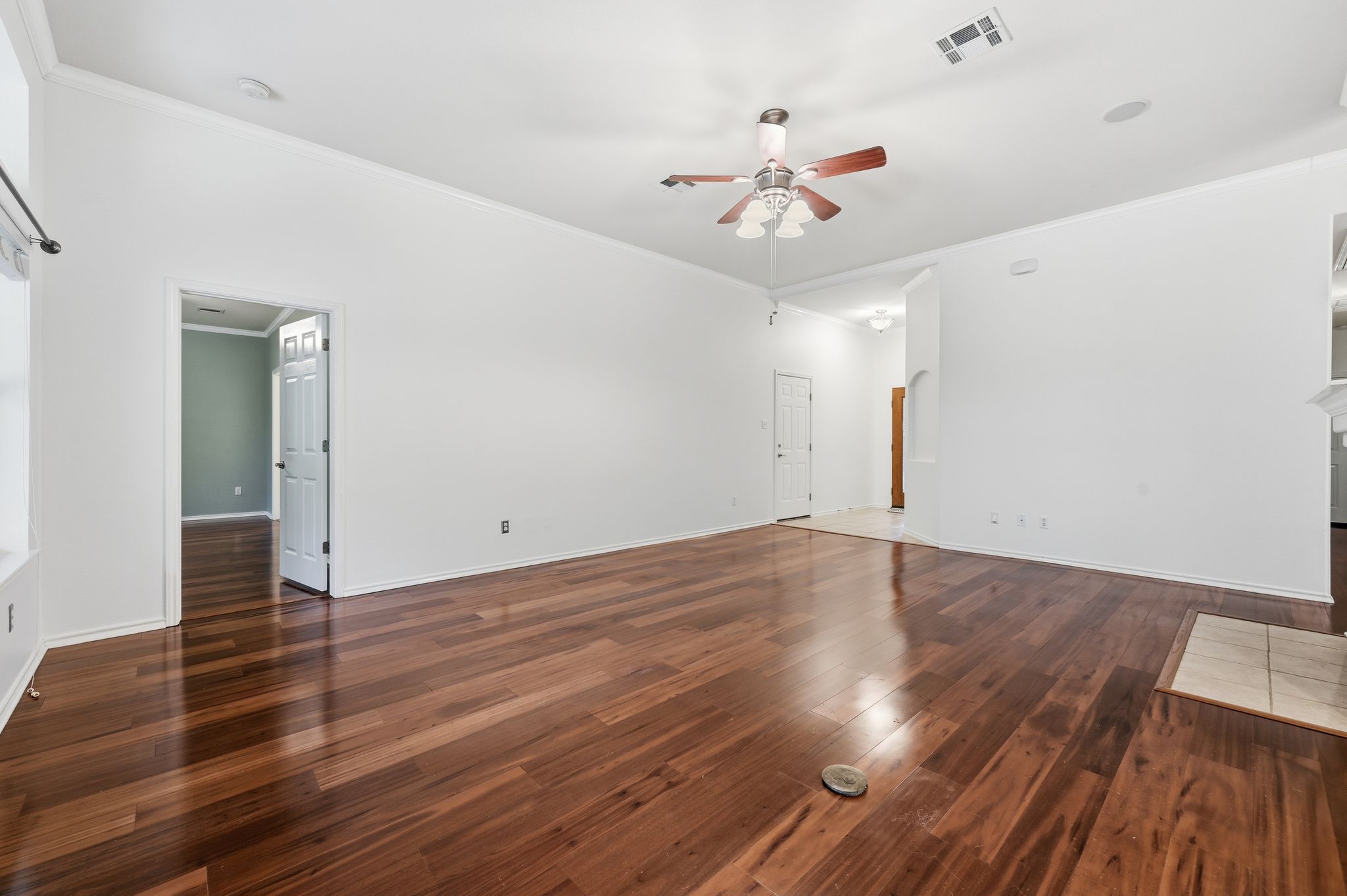 202 Muscovy Lane Cedar Park, TX 78613 - Photo 5 of 34 a view of an empty room with wooden floor and a ceiling fan