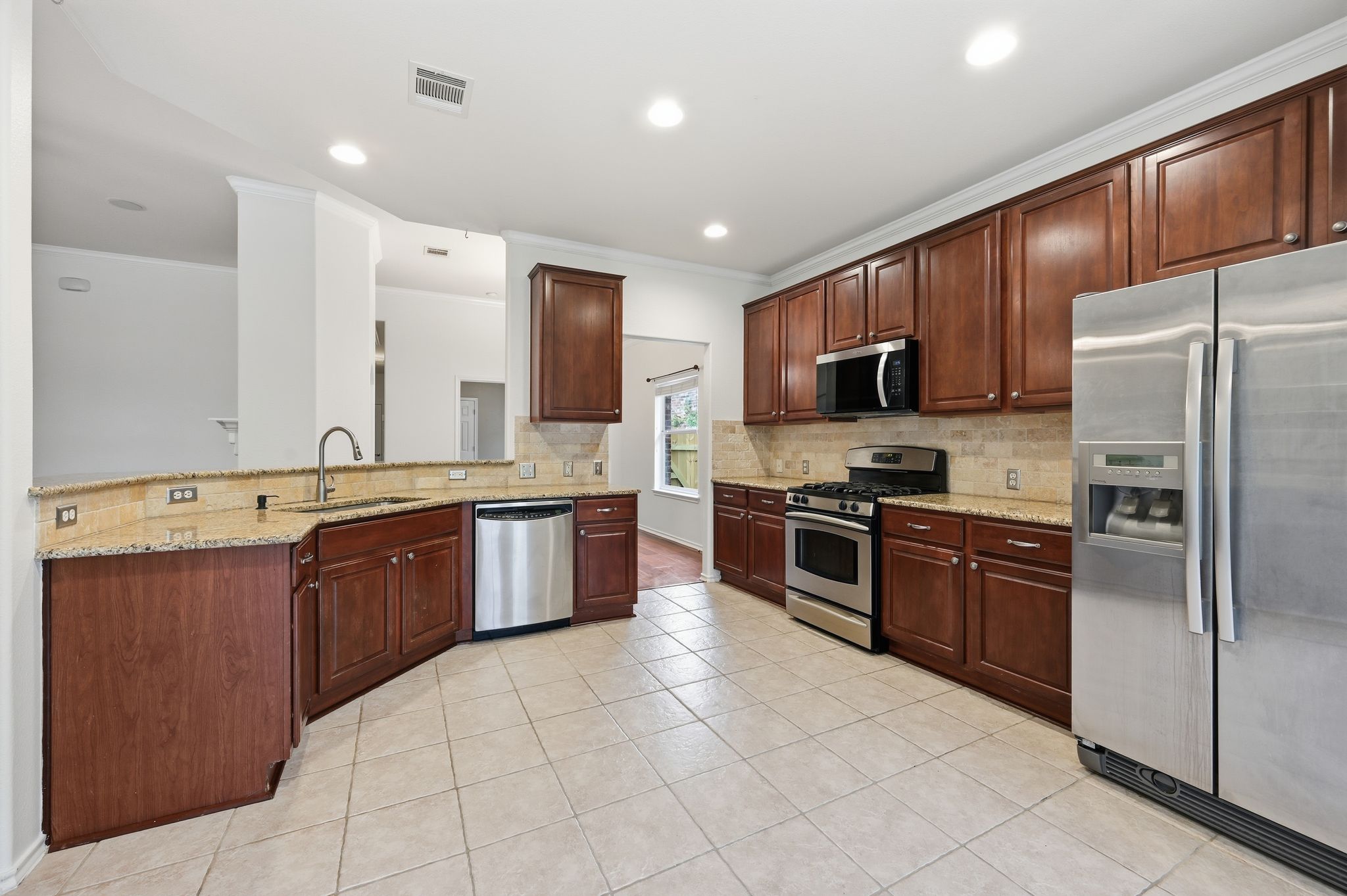 202 Muscovy Lane Cedar Park, TX 78613 - Photo 6 of 34 a large kitchen with a large counter top stainless steel appliances and cabinets