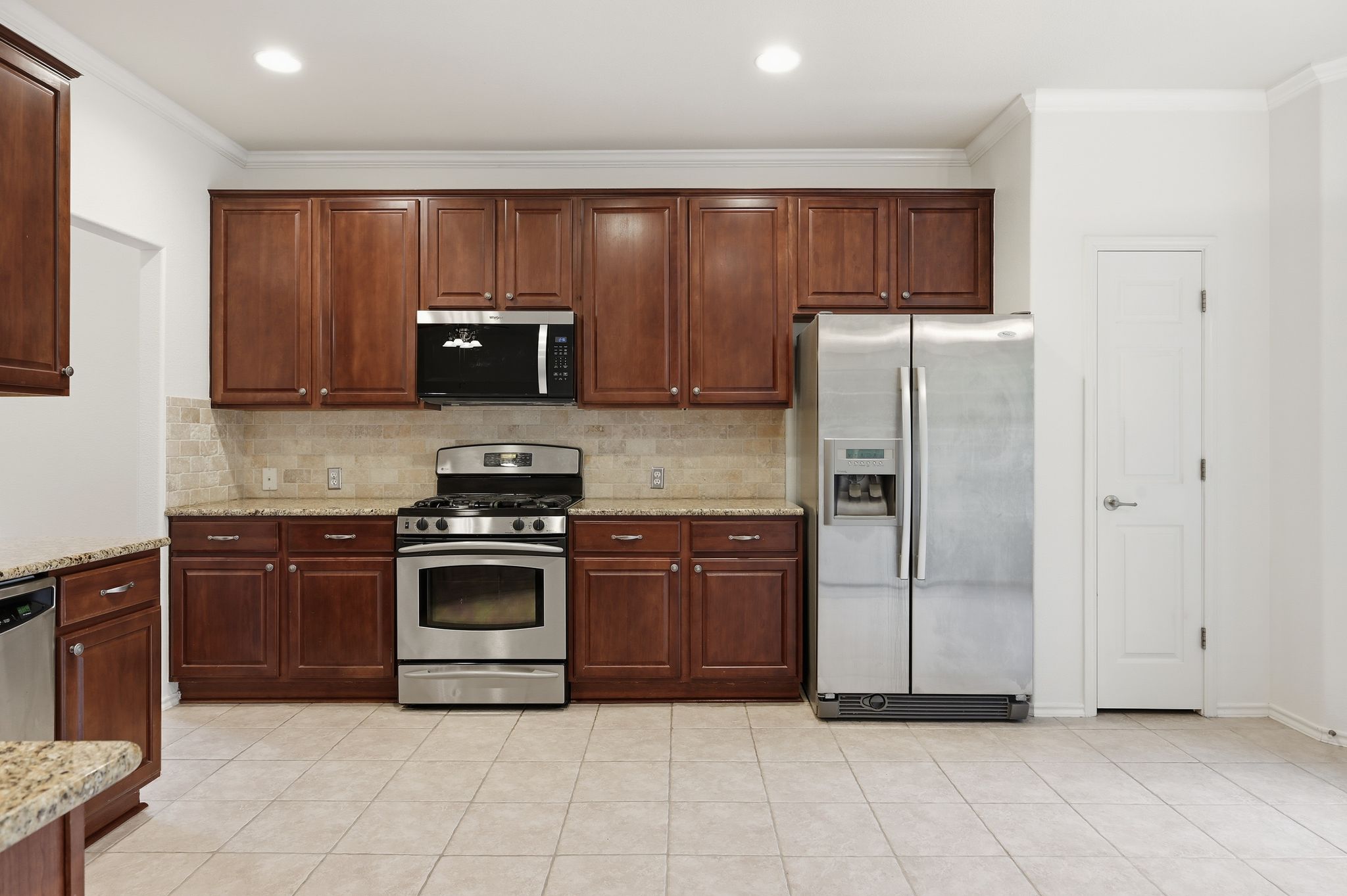202 Muscovy Lane Cedar Park, TX 78613 - Photo 8 of 34 a kitchen with granite countertop wooden cabinets and stainless steel appliances