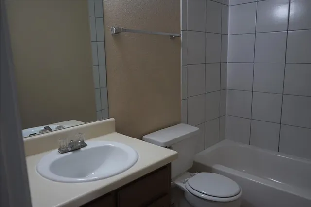 a bathroom with a sink a toilet and bathtub