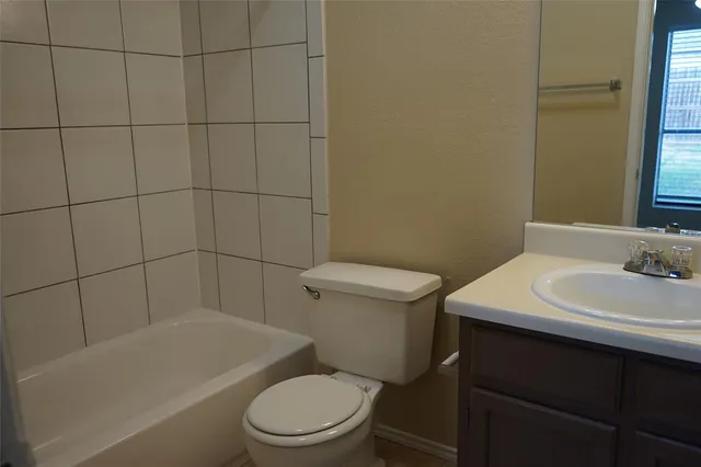 a bathroom with a sink a toilet and bathtub