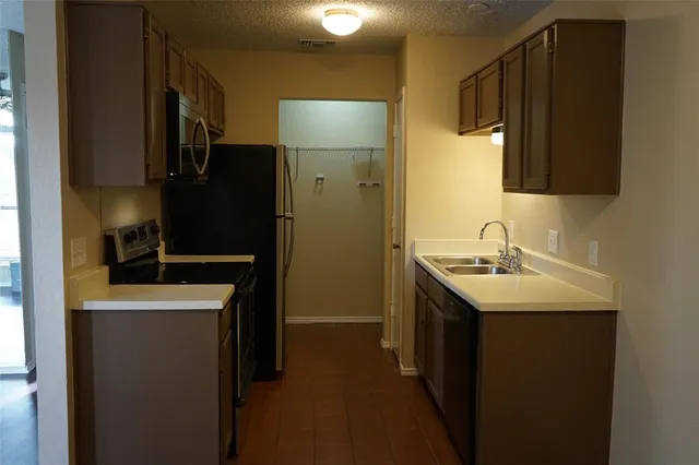 a utility room with cabinets washer and dryer
