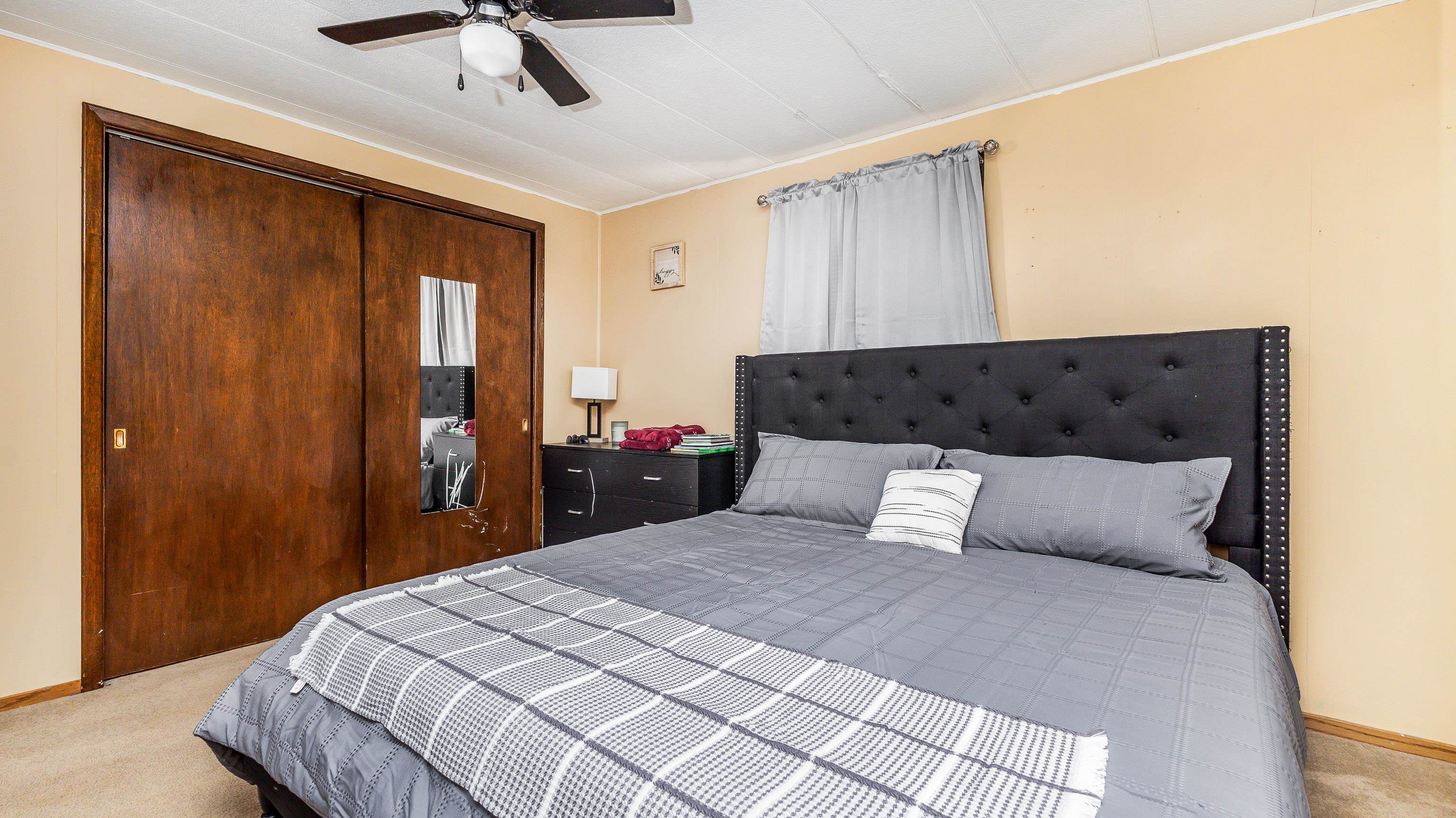 620 Clinton Street Galena, IL 61036 - Photo 20 of 37 a bedroom with a large bed and wooden floor