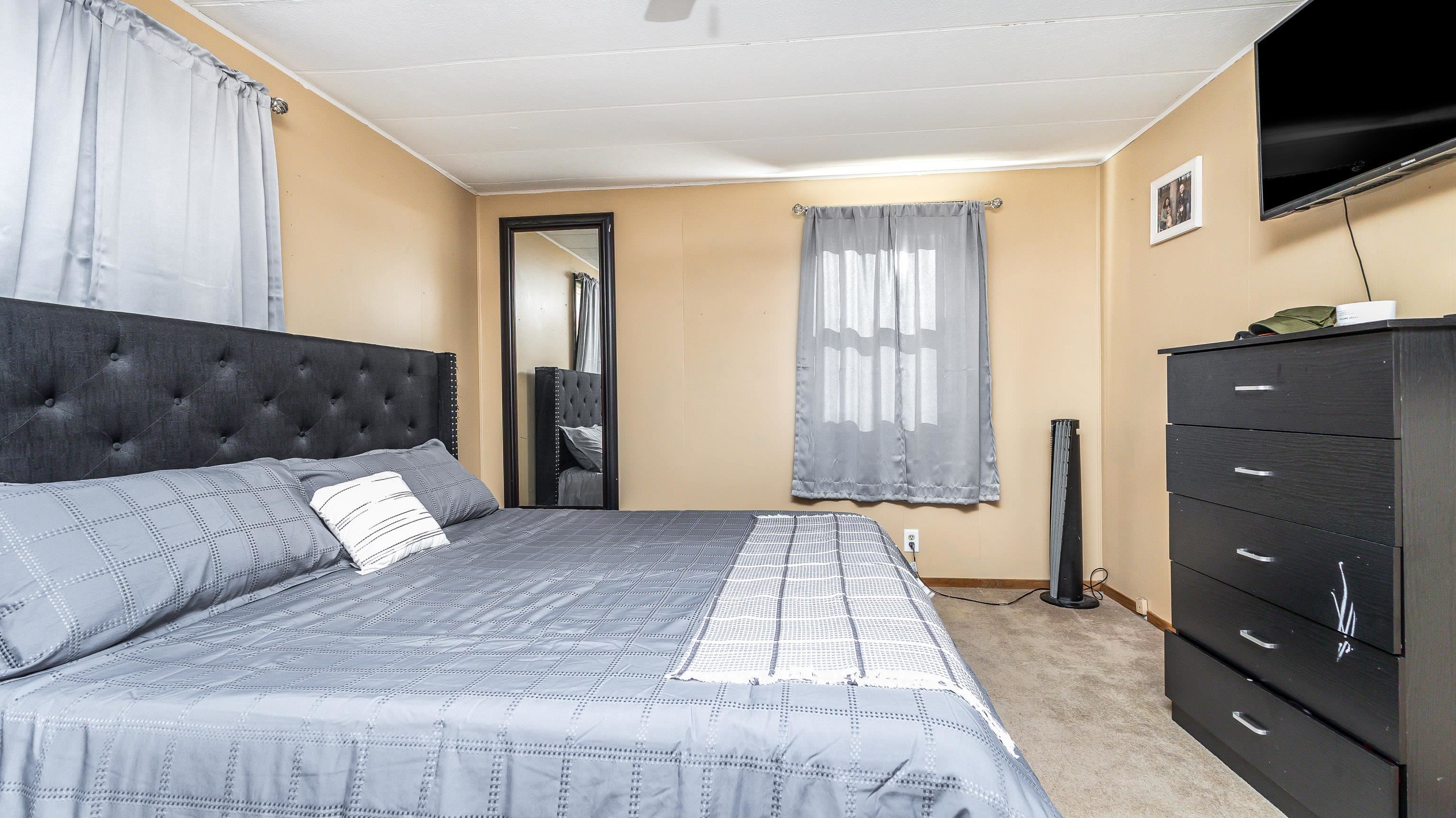 620 Clinton Street Galena, IL 61036 - Photo 4 of 37 a bedroom with a large bed and a flat screen tv