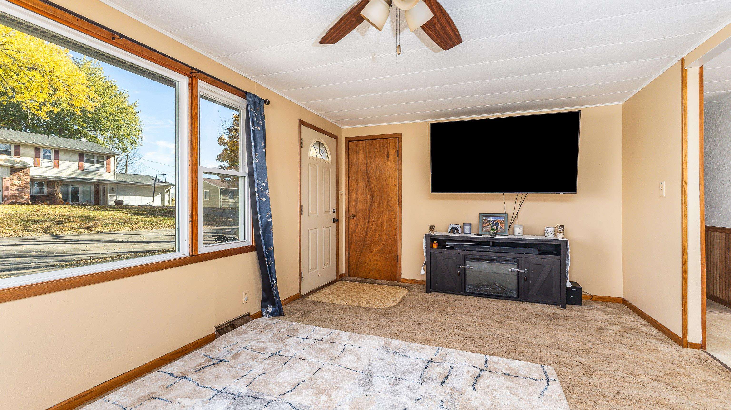 620 Clinton Street Galena, IL 61036 - Photo 9 of 37 a living room with a flat screen tv and floor to ceiling window