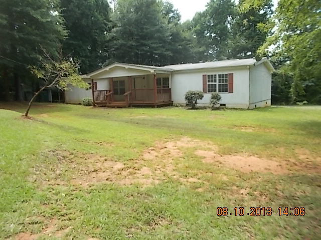 a front view of house with yard and trees