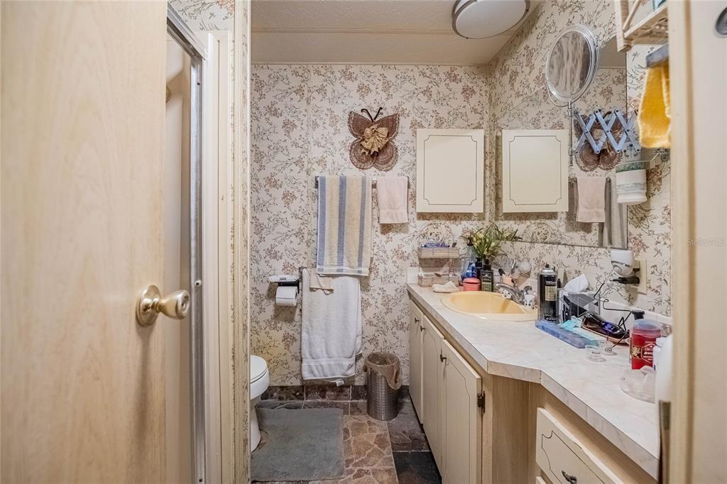 2055 South Floral Avenue, Unit 306 Bartow, FL 33830 - Photo 22 of 42 a view of a bathroom with a sink and a shower curtain