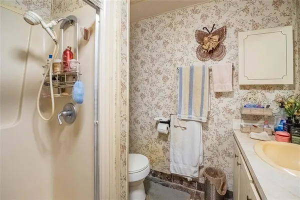 a bathroom with a sink toilet and shower