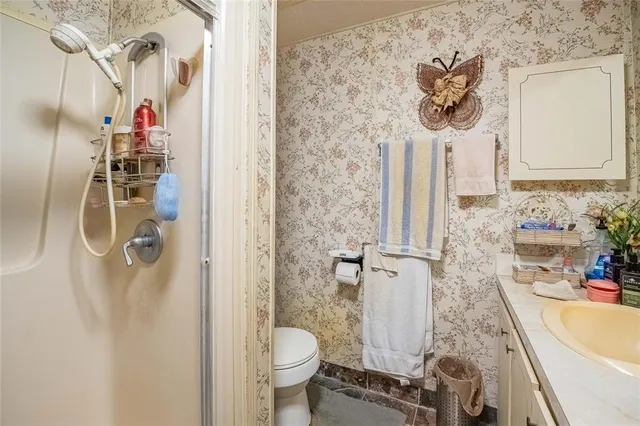 a bathroom with a sink toilet and shower