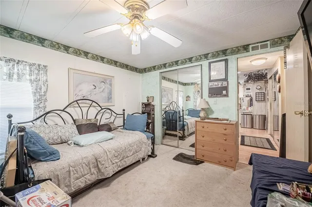 a bedroom with furniture and large windows