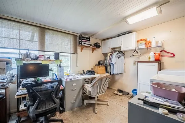 a view of a workspace with furniture and a window