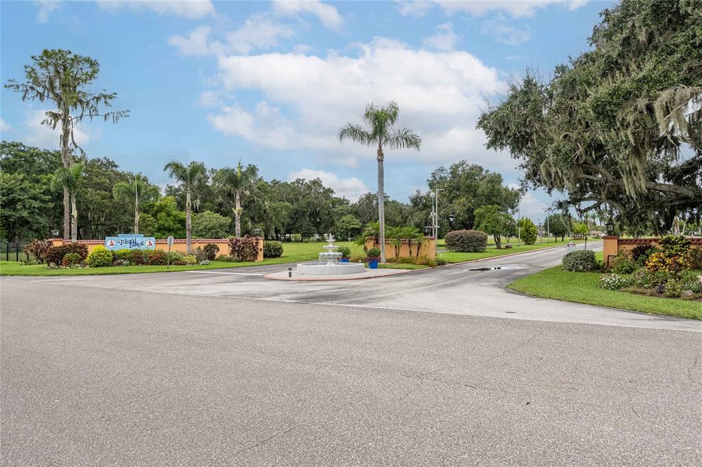2055 South Floral Avenue, Unit 306 Bartow, FL 33830 - Photo 34 of 42 a view of a tall buildings with a big yard and large trees