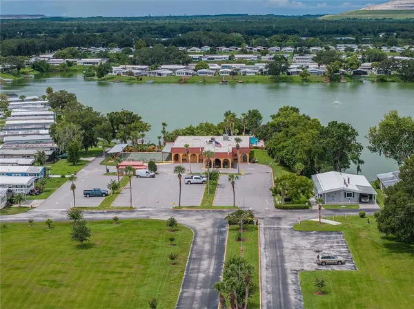 an aerial view of residential houses with outdoor space and lake view