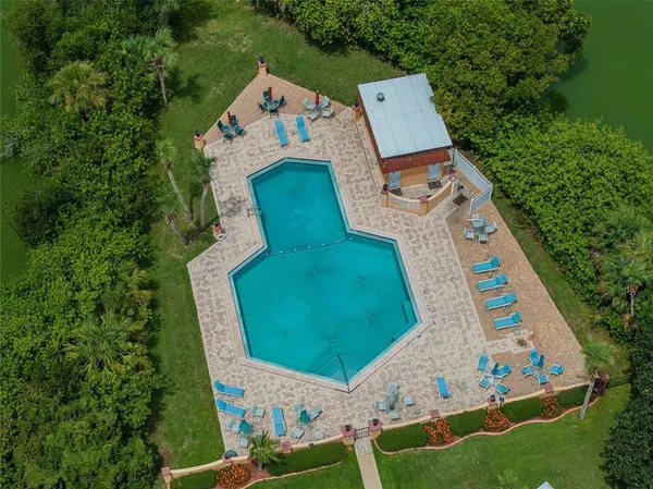 an aerial view of a house with a yard and trees