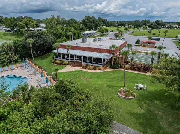 an aerial view of a house with a garden and lake view