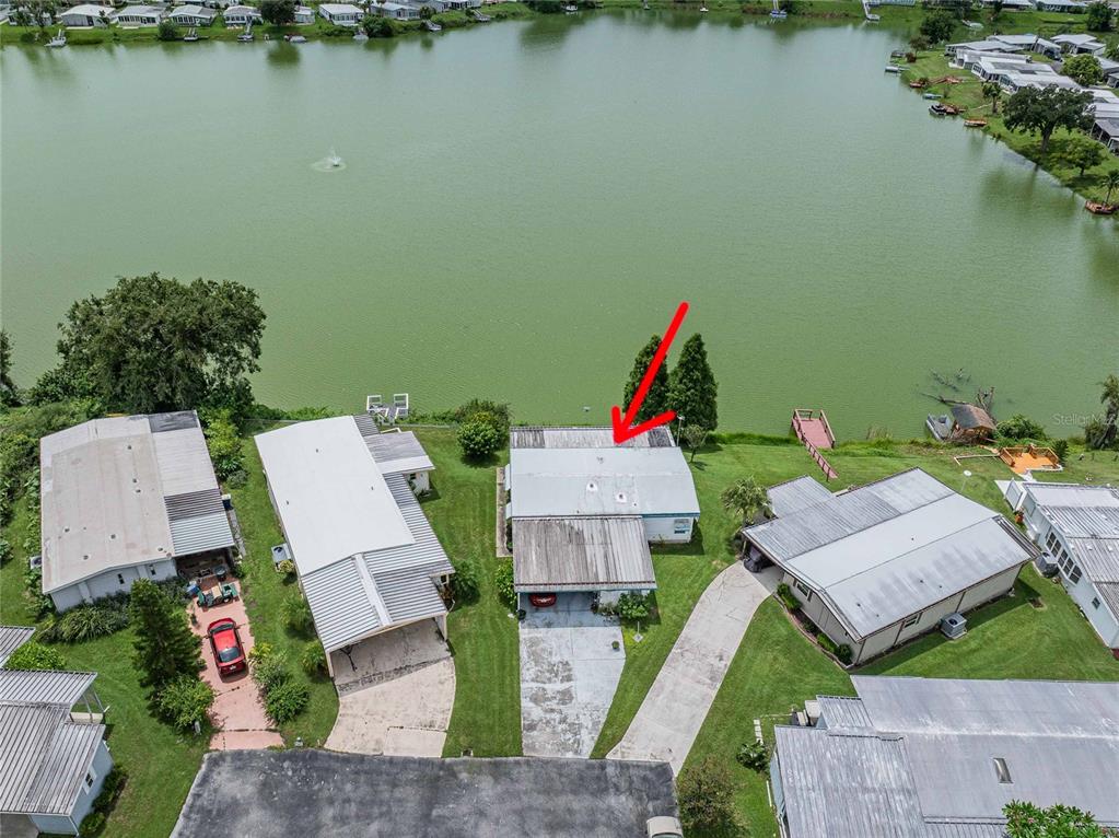 2055 South Floral Avenue, Unit 306 Bartow, FL 33830 - Photo 4 of 42 an aerial view of a house with swimming pool and lake view