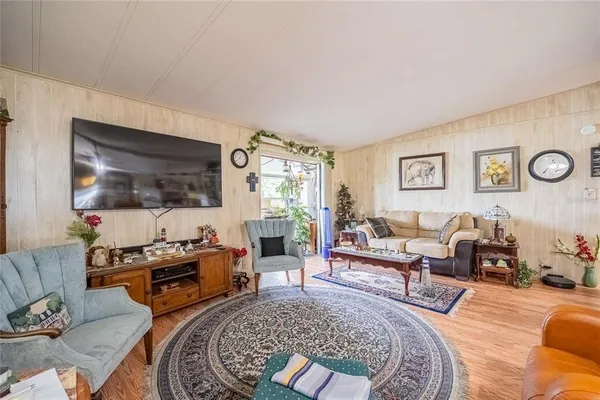a living room with furniture flat screen tv and couches