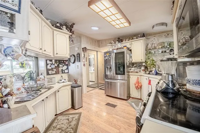 a kitchen with a sink appliances and cabinets