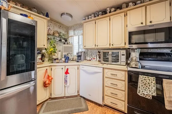 a kitchen with stainless steel appliances a stove and a microwave