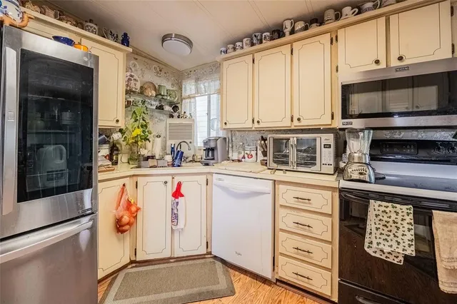a kitchen with stainless steel appliances a stove and a microwave