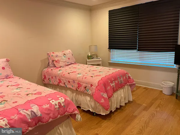 a bedroom with two beds and a potted plant