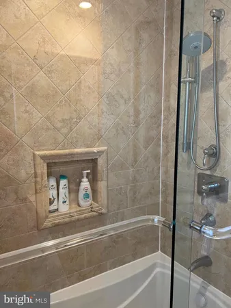 a bathroom with bathtub and a shower