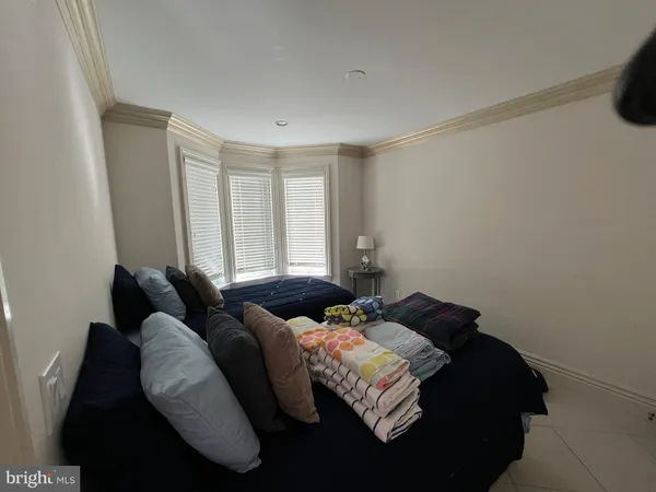 a bedroom with bed and a window