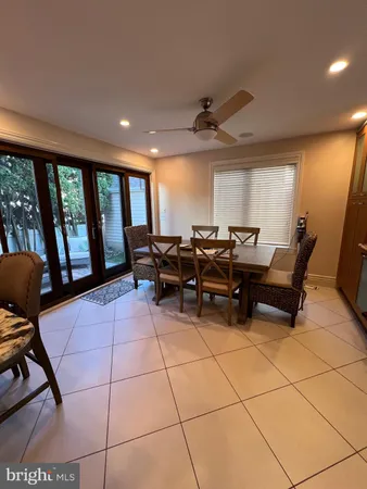 a living room with furniture and large windows