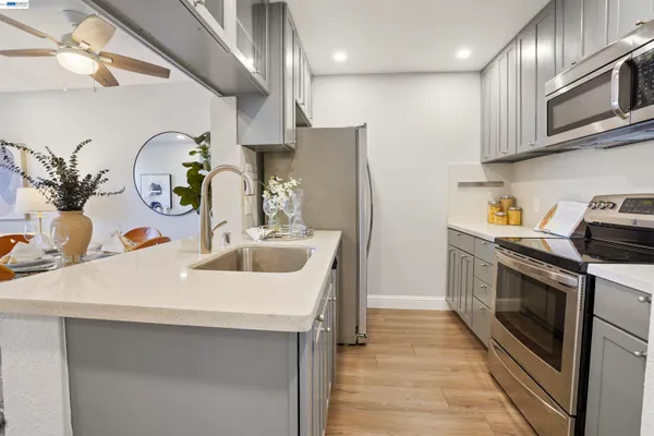 a kitchen with stainless steel appliances a sink a stove and a refrigerator